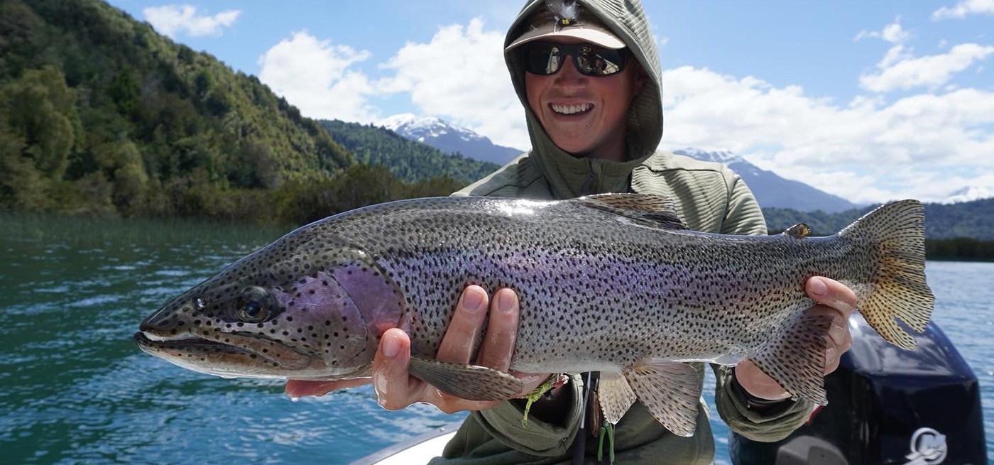 Nathan Davis, TroutHunter guide, holds up a large rainbow trout